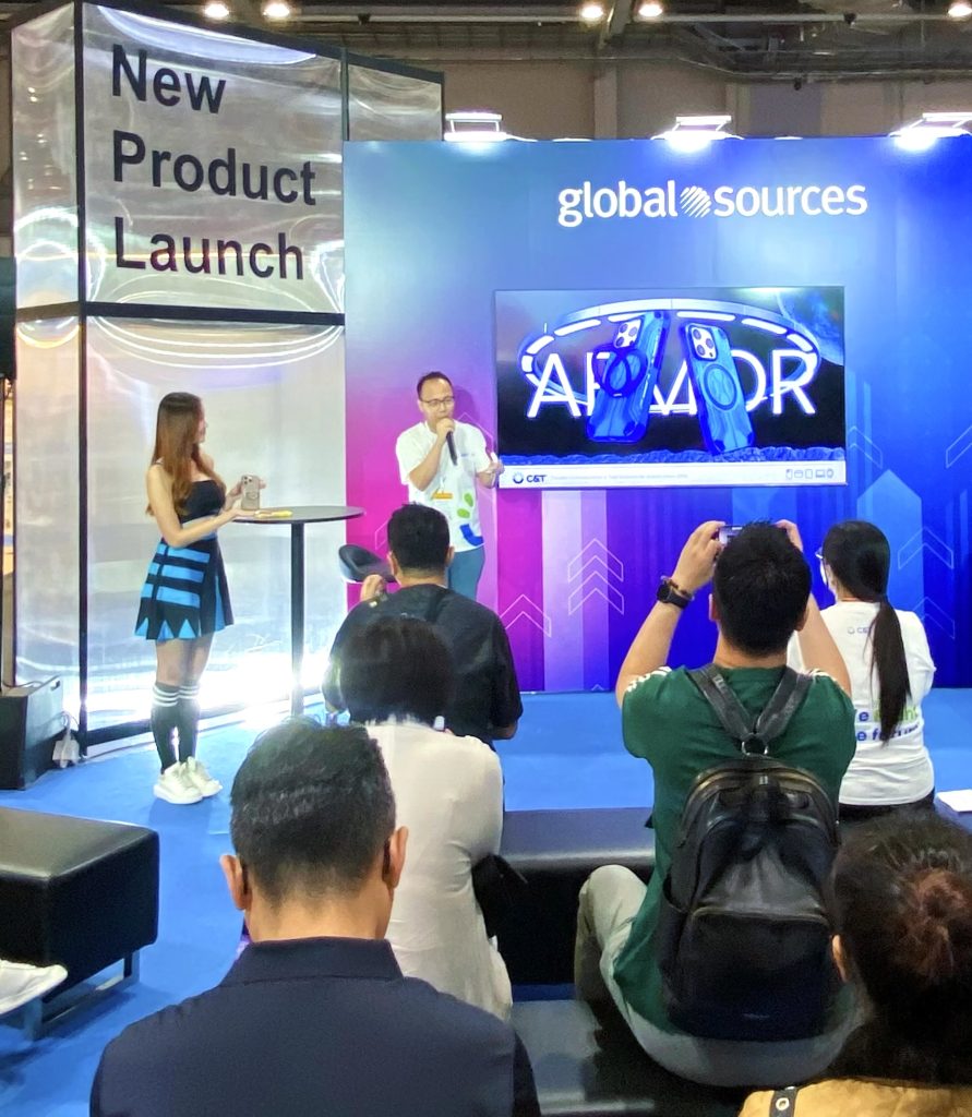 Team members presenting new phone case designs to visitors at Hong Kong Expo
