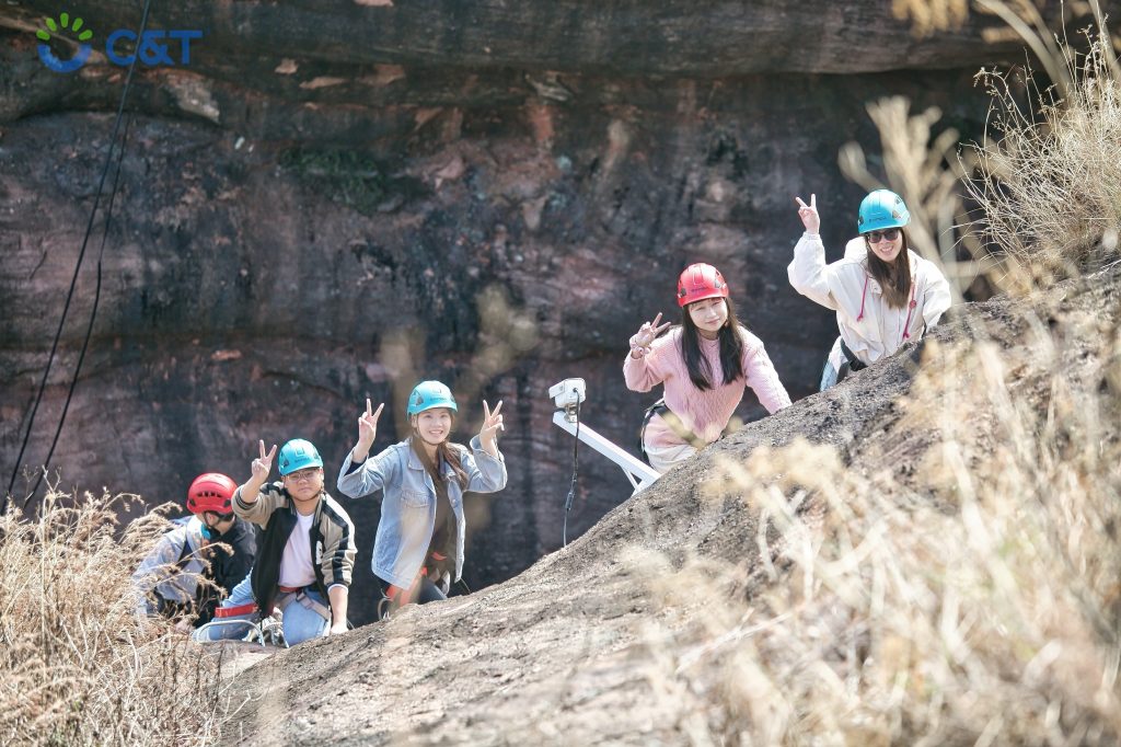 C&T Team members conquering climbing challenges together in Qingyuan