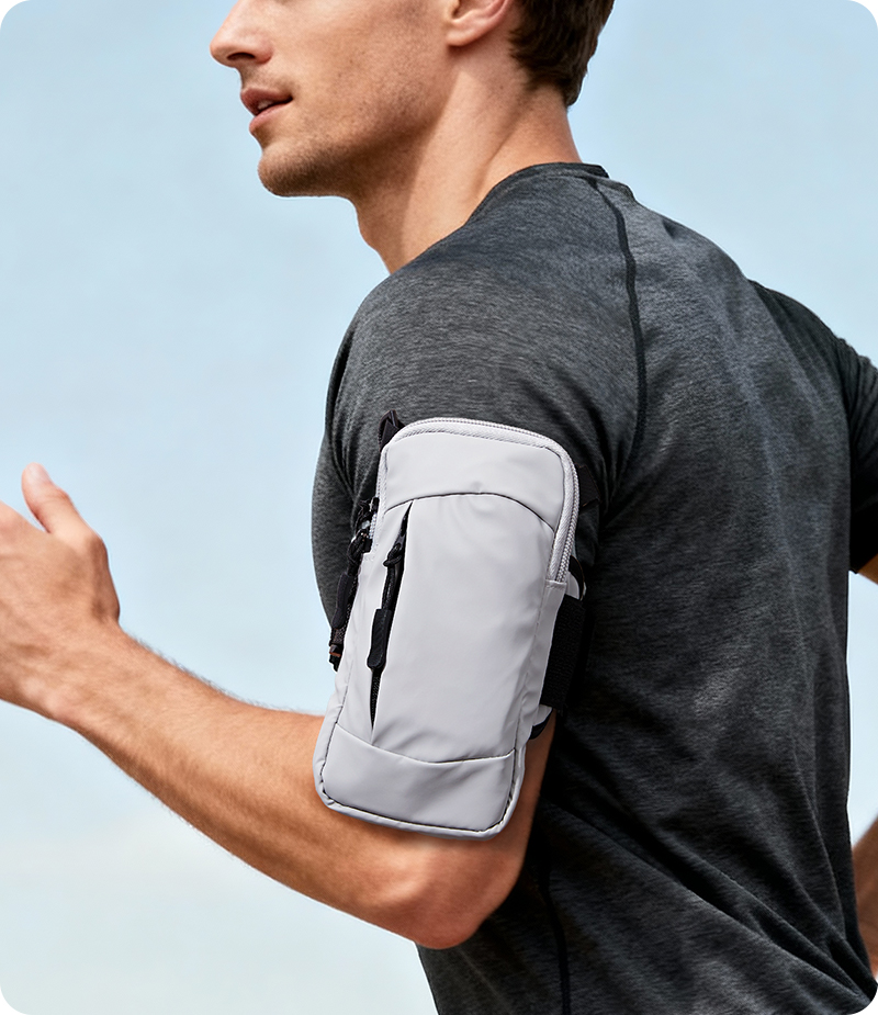 Runner wearing a compact phone pouch on arm